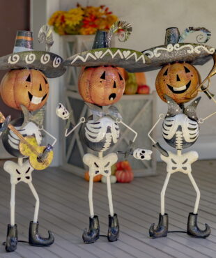 A Trio of Miriachi Skeletons Holding Hortns, Guitars and Maracas- Wearing Sombrero Hats