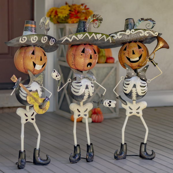 A Trio of Miriachi Skeletons Holding Hortns, Guitars and Maracas- Wearing Sombrero Hats