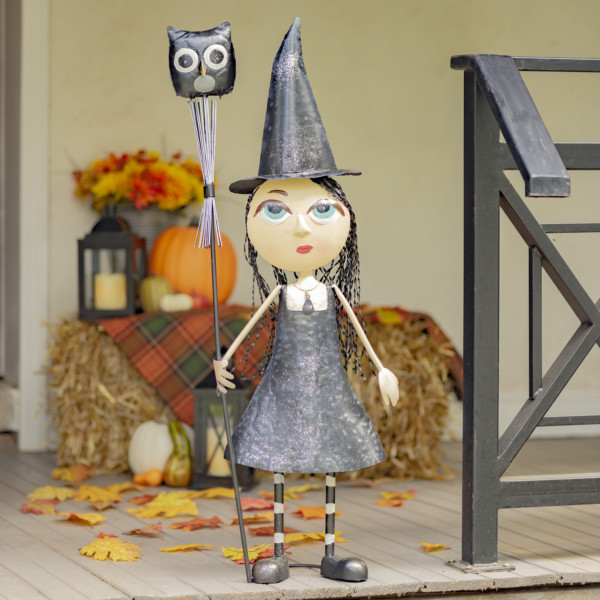 Halloween decoration of Tall Metal Big eye witch girl wearing a black dress and pointed hat holding a stake