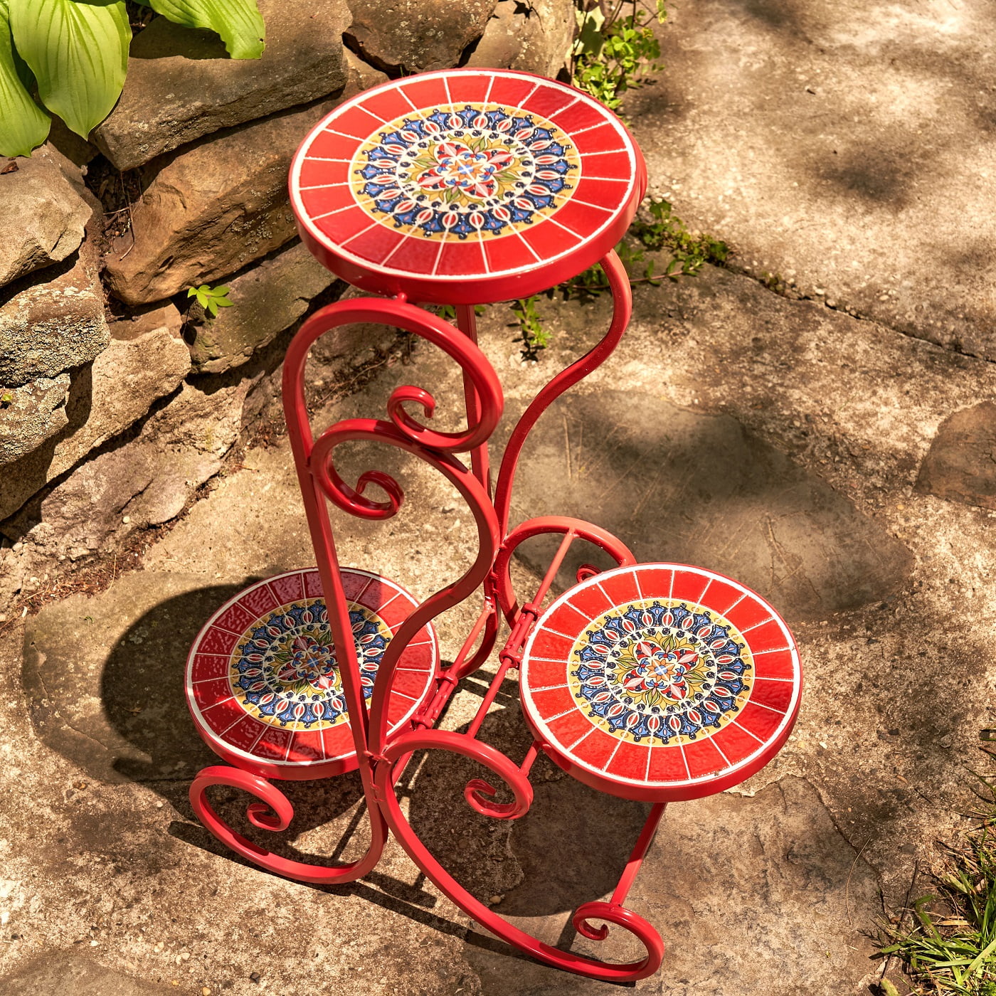 top view image of 3 tier iron plant stand with mosaic tiles in glossy red finish in garden