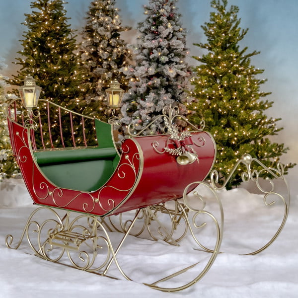Large Victorian Christmas sleigh in red, green and gold with 2 lanterns on each side and filigree details