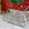 close up silver rails of large Christmas sleigh with filigree details