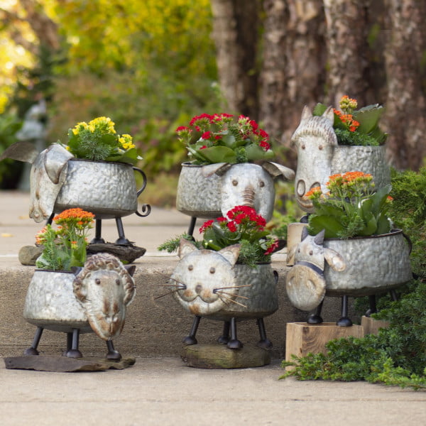 six assorted galvanized metal planters shaped like a cow, cat, dog, sheep., horse, and pig