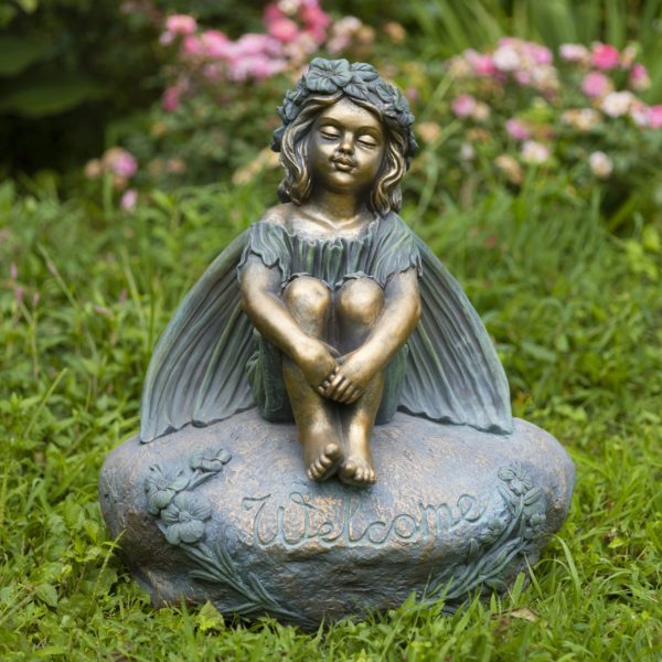 25 inch tall magnesium fairy garden statue sitting on welcome stone with closed eyes and arms around legs
