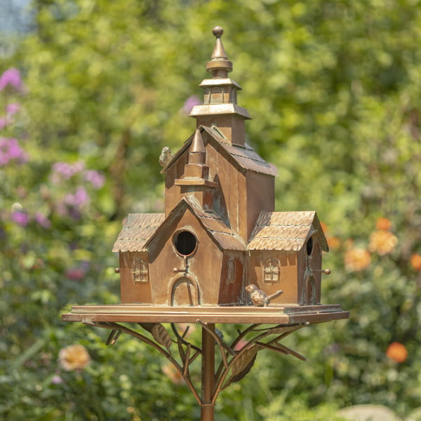Large copper-colored multi-home birdhouse stake montana with little metal birds perched on it