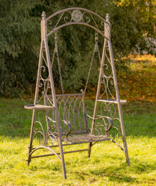 Antique bronze iron swing chair with curlicue designs on the sides