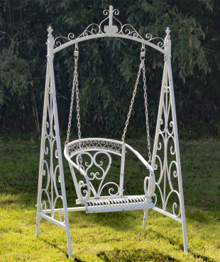 Angled Full View of Antique White Swing Chair Hanging From an Iron Chain