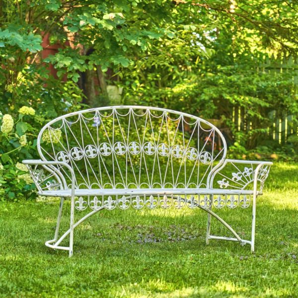 Iron garden bench with curved back and fleur-de-lis details in antique white finish