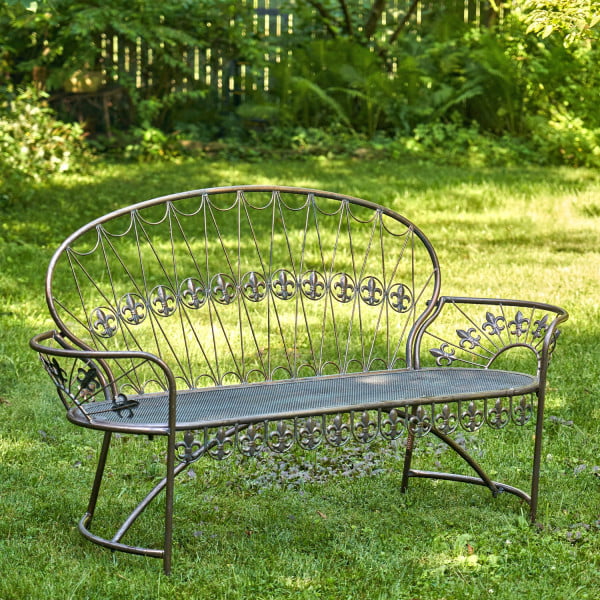 Iron garden bench with curved back and fleur-de-lis details in antique copper finish