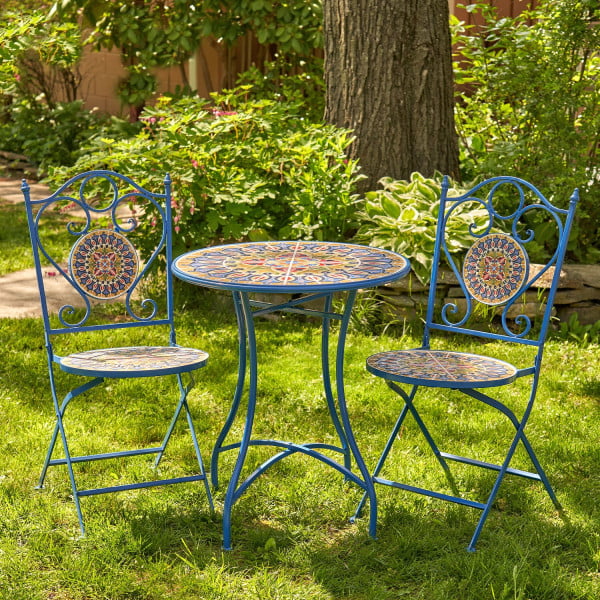Bistro set with 2 folding chairs and 1 round table with dark blue iron frame and multicolor mosaic tiles in a garden