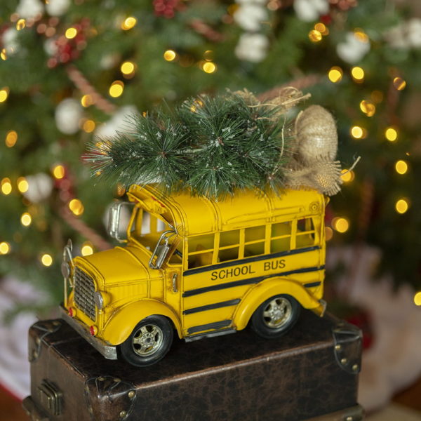 Vintage style yellow school bus model with Christmas tree in a roof tabletop decor