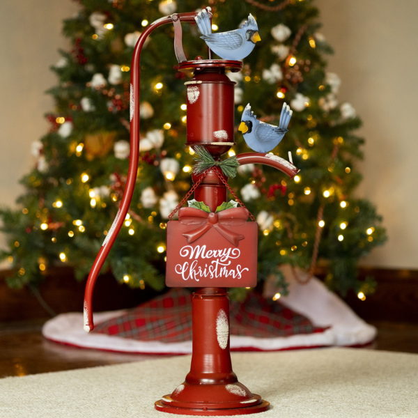 31 inch tall old style iron Christmas water pump in antique red finish and faux snow patches with Merry Christmas sign and bluebirds