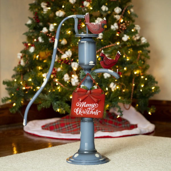 31 inch tall old style iron Christmas water pump in antique blue finish and faux snow patches with Merry Christmas sign and red cardinals