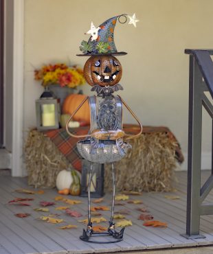 Halloween decoration with tall metal pumpkin witch with an Owl body candy holder