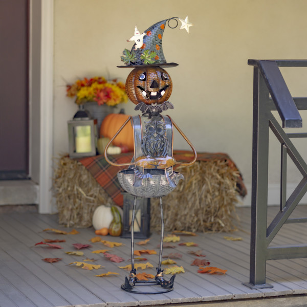 Halloween decoration with tall metal pumpkin witch with an Owl body candy holder
