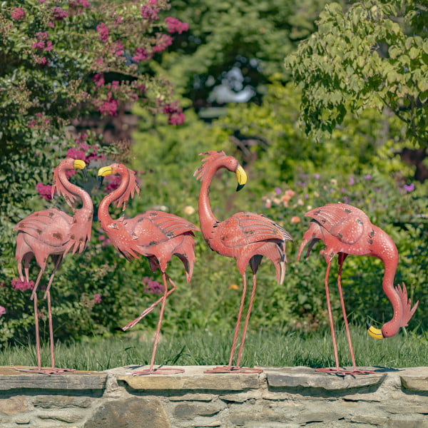 set of 4 pink flamingos metal garden figurines standing in garden