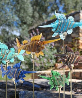 Six painted glass swordfish in light blue,green, yellow, brown, dark blue and sea blue with gold plated iron pot stake