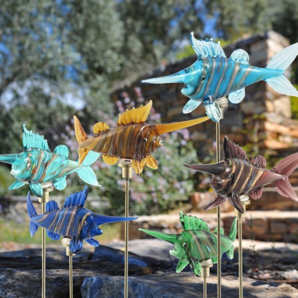 Six painted glass swordfish in light blue,green, yellow, brown, dark blue and sea blue with gold plated iron pot stake