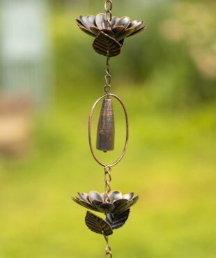 closed up image if iron rain chain with peonies and chimes in antique bronze