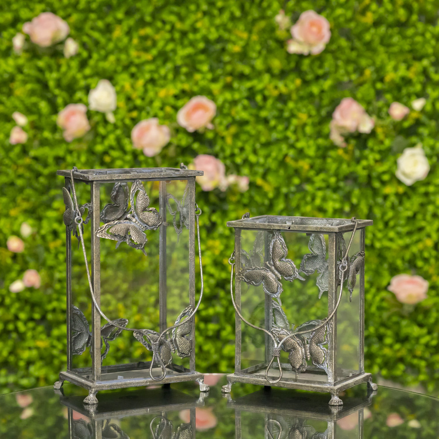 One small and one large frosted silver lantern with butterfly design