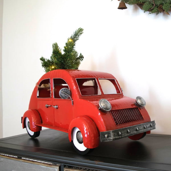 vintage style metal glossy red car with Christmas tree on top