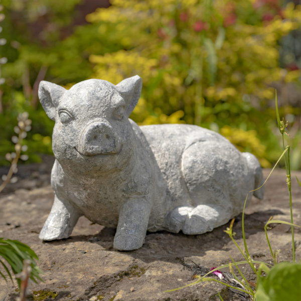 Statue of one of the piglet from the set which is sitting