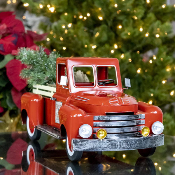 small red metal truck decoration with Christmas tree in trunk