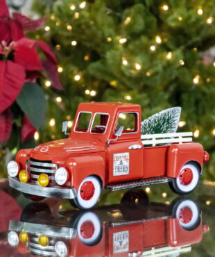 small red metal truck tabletop decoration with Christmas tree in trunk