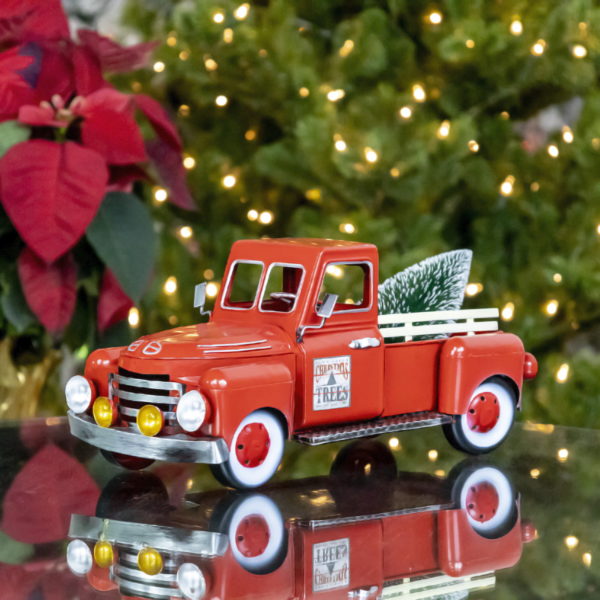 small red metal truck tabletop decoration with Christmas tree in trunk