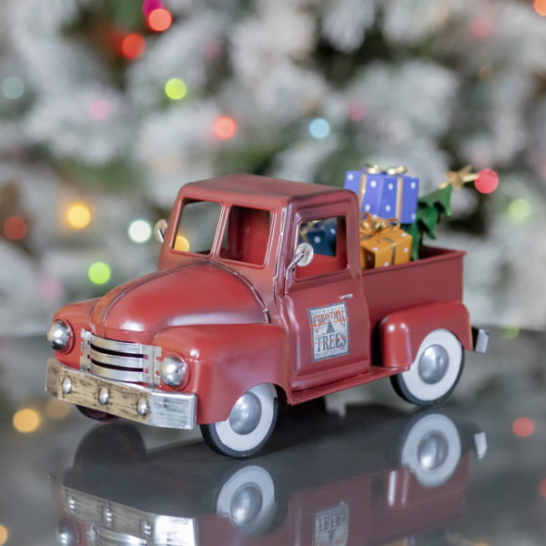 left side of Small antique red Metal truck with Christmas tree and gifts in the back