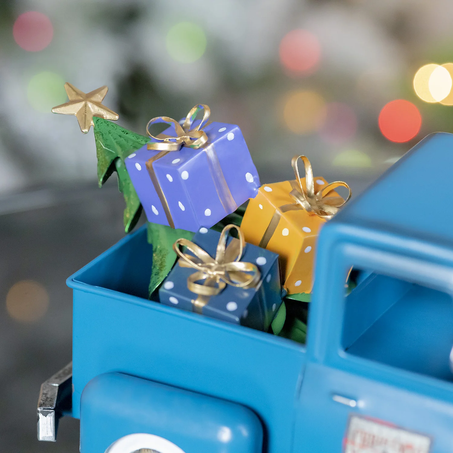 View of Gifts and Christmas Tree in the back of the Metal Blue Silver Truck