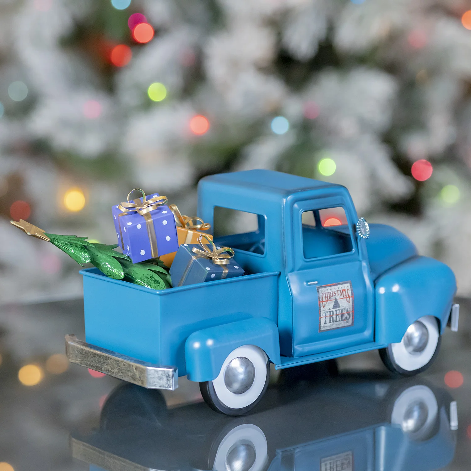Back End of the Small Metal Blue Truck with Christmas Tree and Gifts Filling it