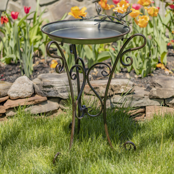 Shallow galvanized tray birdfeeder with three curlicue legs and two birds perched to the top of the birdfeeder
