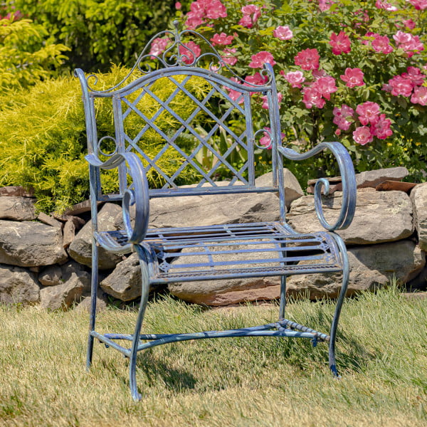 Victorian-style wrought iron garden armchair with lattice backrest and perpendicular slats of the seat with filigree details in antique blue in garden