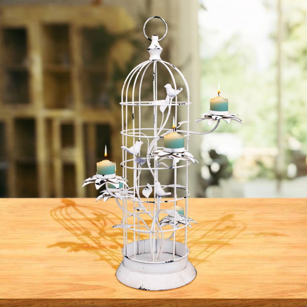 Metal Bird cage candle holder for 5 candles in antique white finish with candle on it