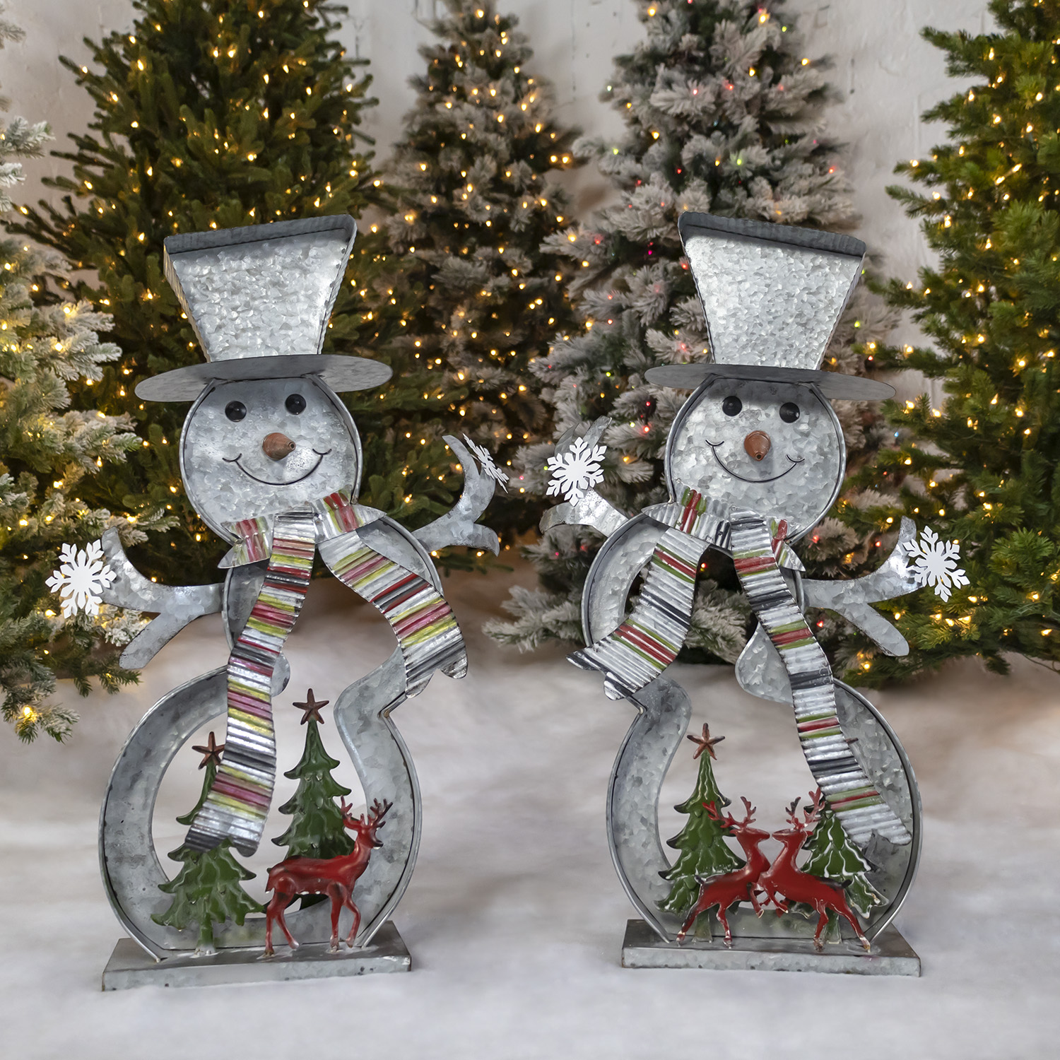 2 galvanized cookie cutter snowmen with Christmas trees and reindeer scene at the base