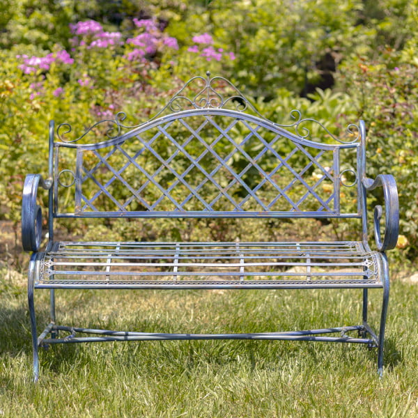 Front view victorian style iron garden bench in antique blue distressed finish with exquisite lattice backrest with filigree details juxtaposed with the perpendicular slats of the seat in garden