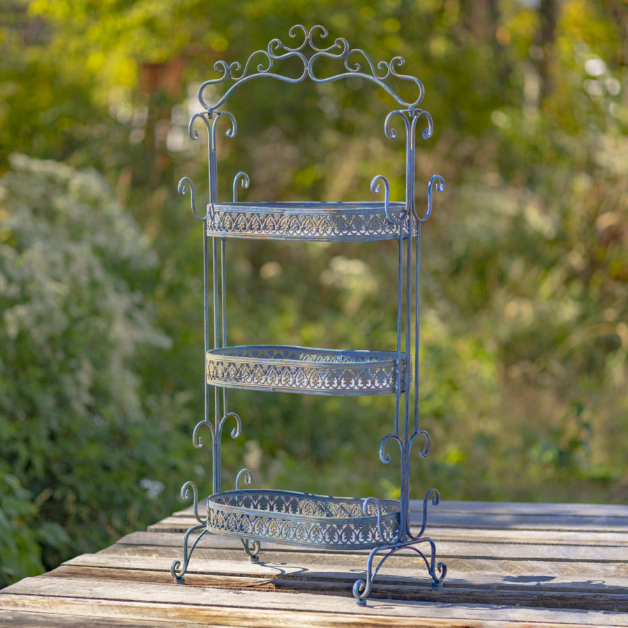 Full image of an Antique Blue three tier Plant Stand with curlicue designs at the top, sides and bottom of the item