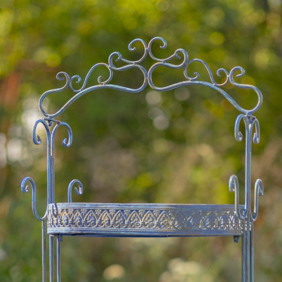 Close up image of the first tier of the Antique Blue Plant Stand showing you the curlicue design at the top of the item