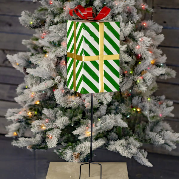 37 inch tall metal green and white striped Christmas gift box stake with red metal ribbon on top of it