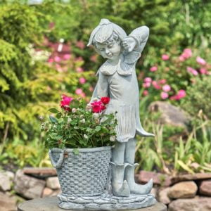 two and a half foot tall fairy garden statue with large basket planter full of flowers