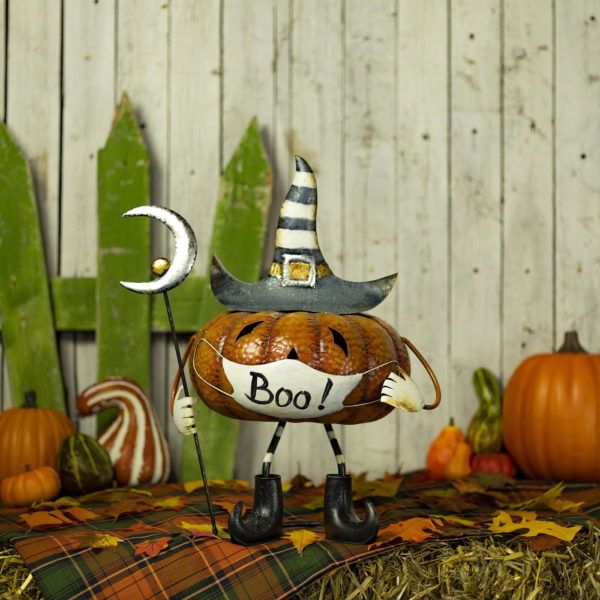 iron Halloween pumpkin figurine with face mask in witch hat holding staff