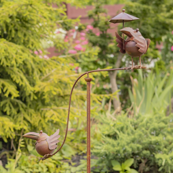 Garden Stakes with two birds balancing on either end and one of them sheltering with an umbrella