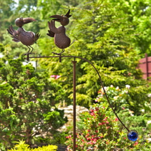 rust colored balance stake kinetic garden decoration with birds