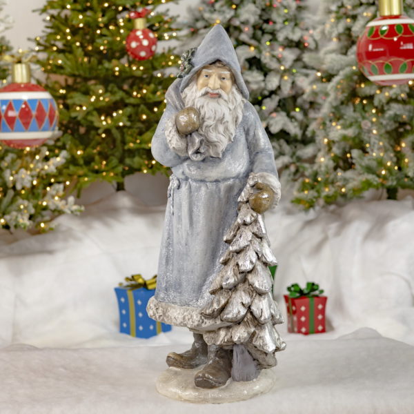 Full View of Santa Clause with Blue Cloak Holding a Sack of Gifts and a Christmas Tree