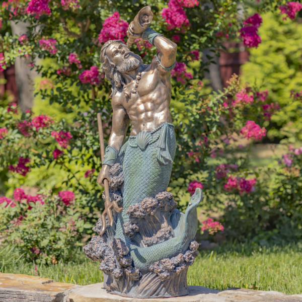 Tall antique bronze merman garden statue holding a seashell spyglass in one hand and in the other holding a trident with his long hair and muscular body