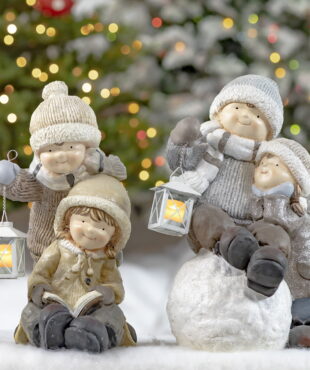 2 Sets of Children Statues- Sitting on a Snowball, Holding Lanterns and Reading a Book- Christmas Tree lights in the background of picture