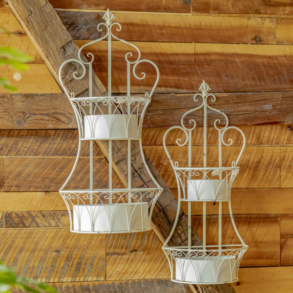 Two dual white hanging iron basket planters with curlicue designs