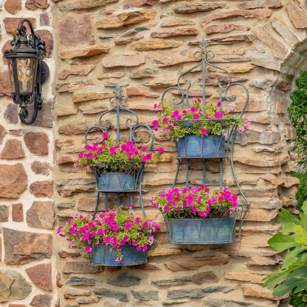 Two dual blue hanging on wall iron basket planters with curlicue designs and plants in it for additional décor ( Plants not included)