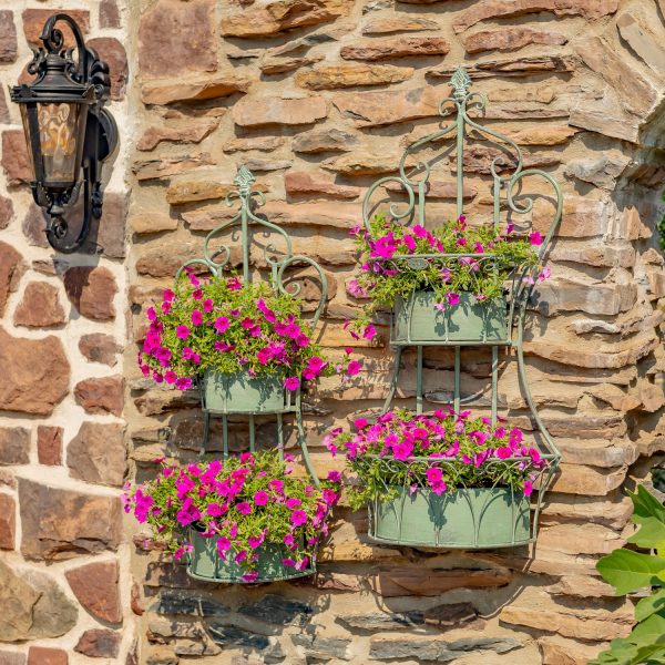 Two dual green hanging on wall iron basket planters with curlicue designs and plants in it for additional décor ( Plants not included)